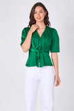 Green satin tie front short sleeve top hands in pockets